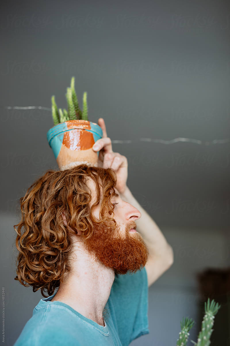 portrait of a man with a flower pot on his head