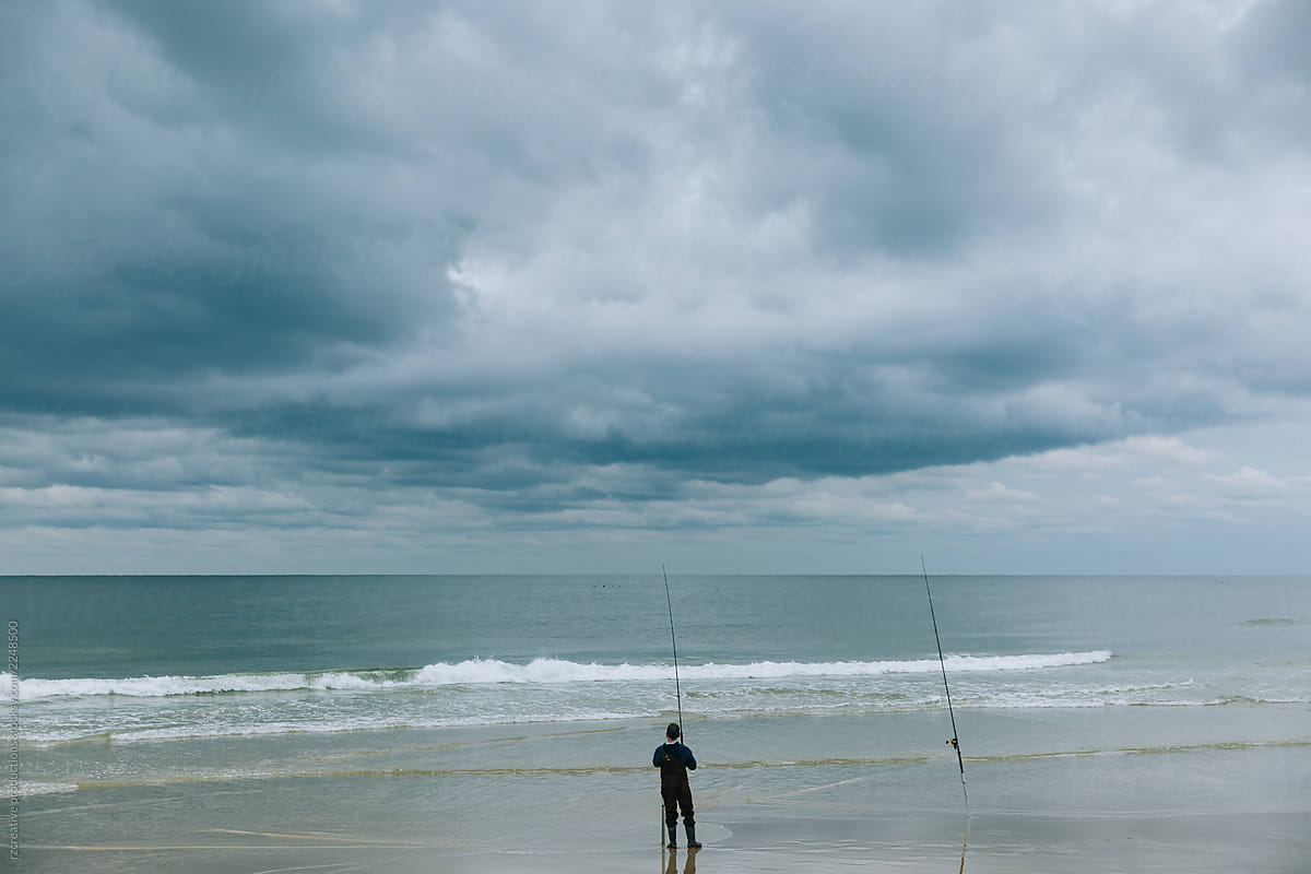 Beach fisherman on a stormy day.