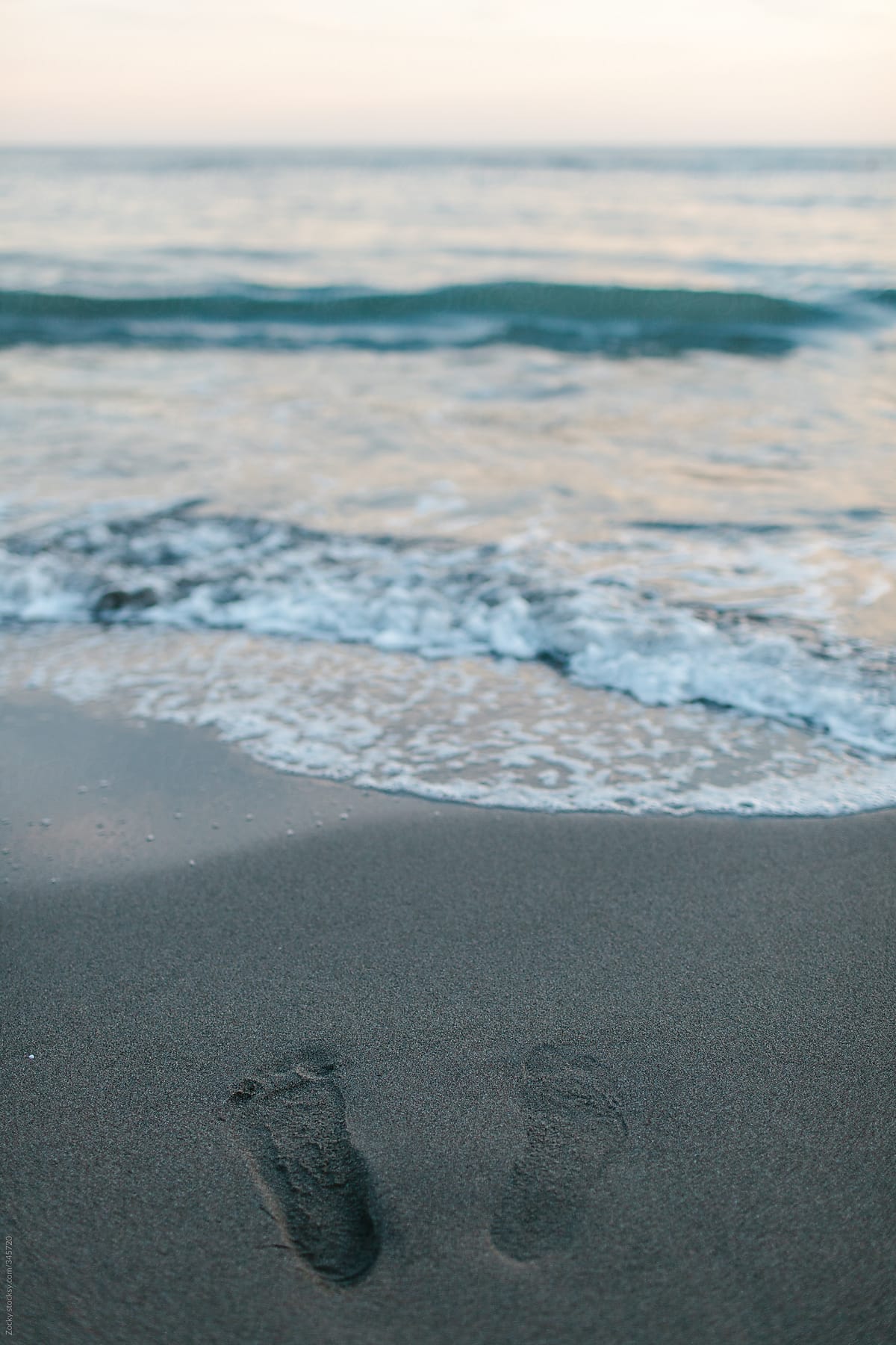 Fresh footprints on a beach