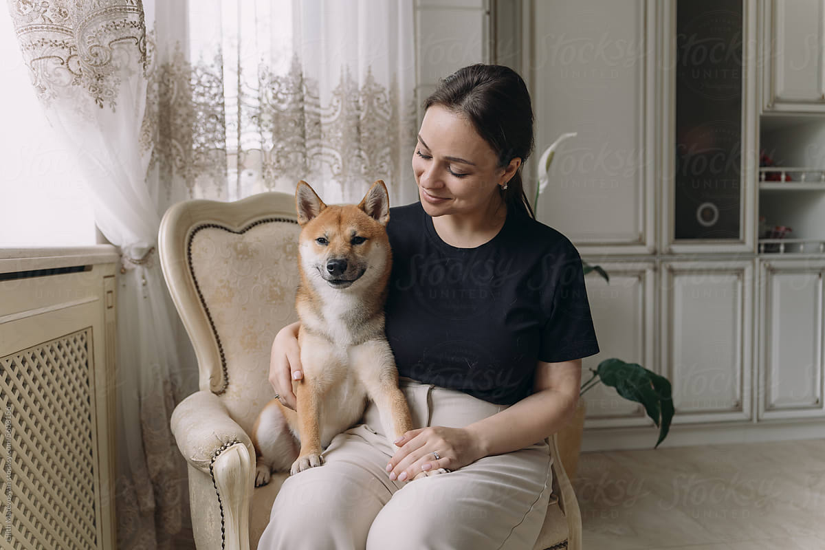 Woman Enjoying With Her Dog At Home