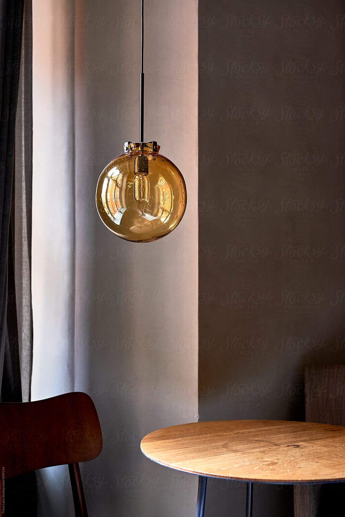 Yellow round ceiling lamp hanging on wire