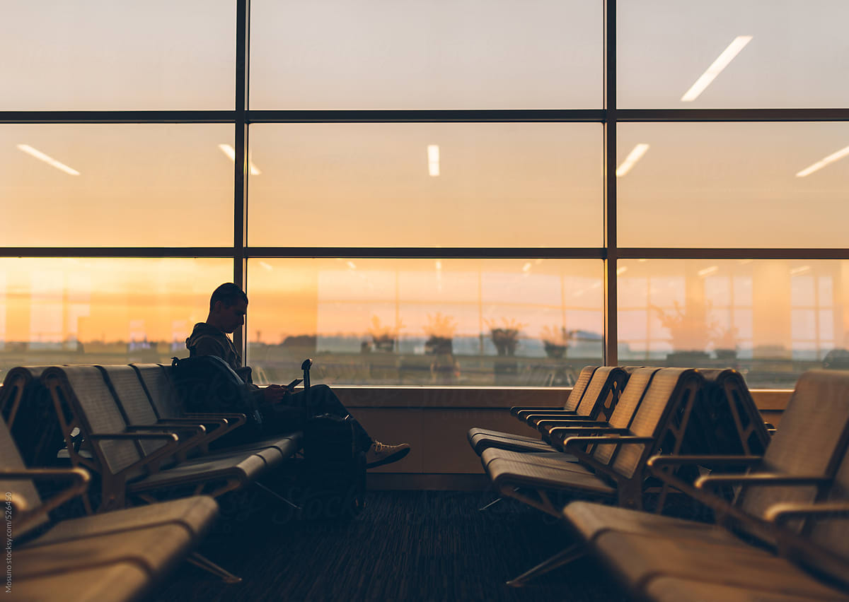Silhouette of a Man Sitting at the Airport Gate