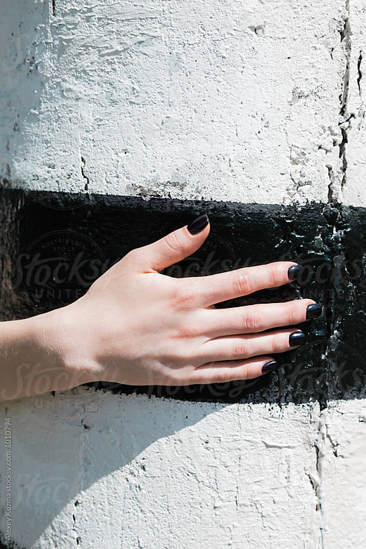 hand of young female with black nail enamel