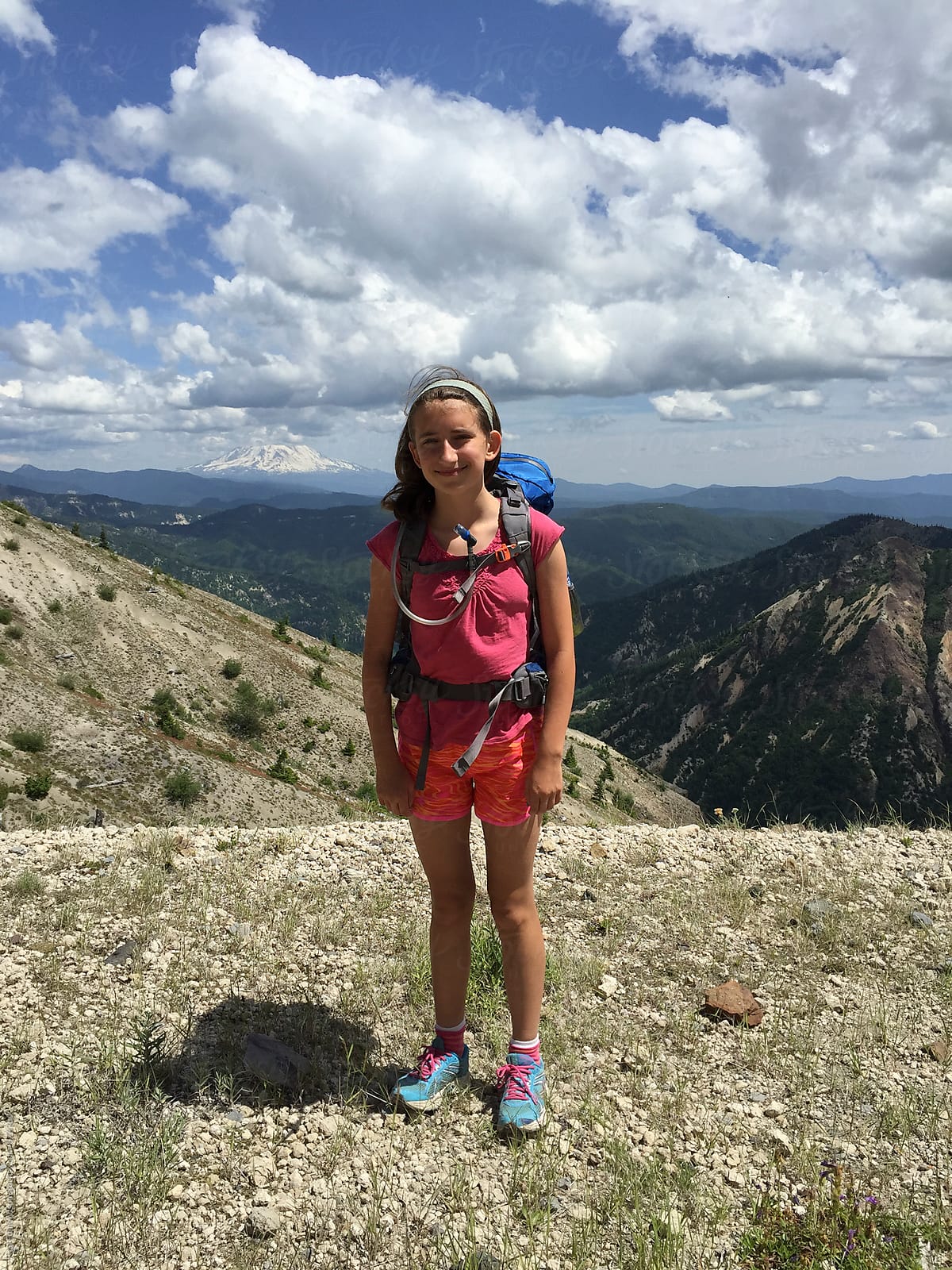 Portrait of adolescent backpacker girl on mountain summit