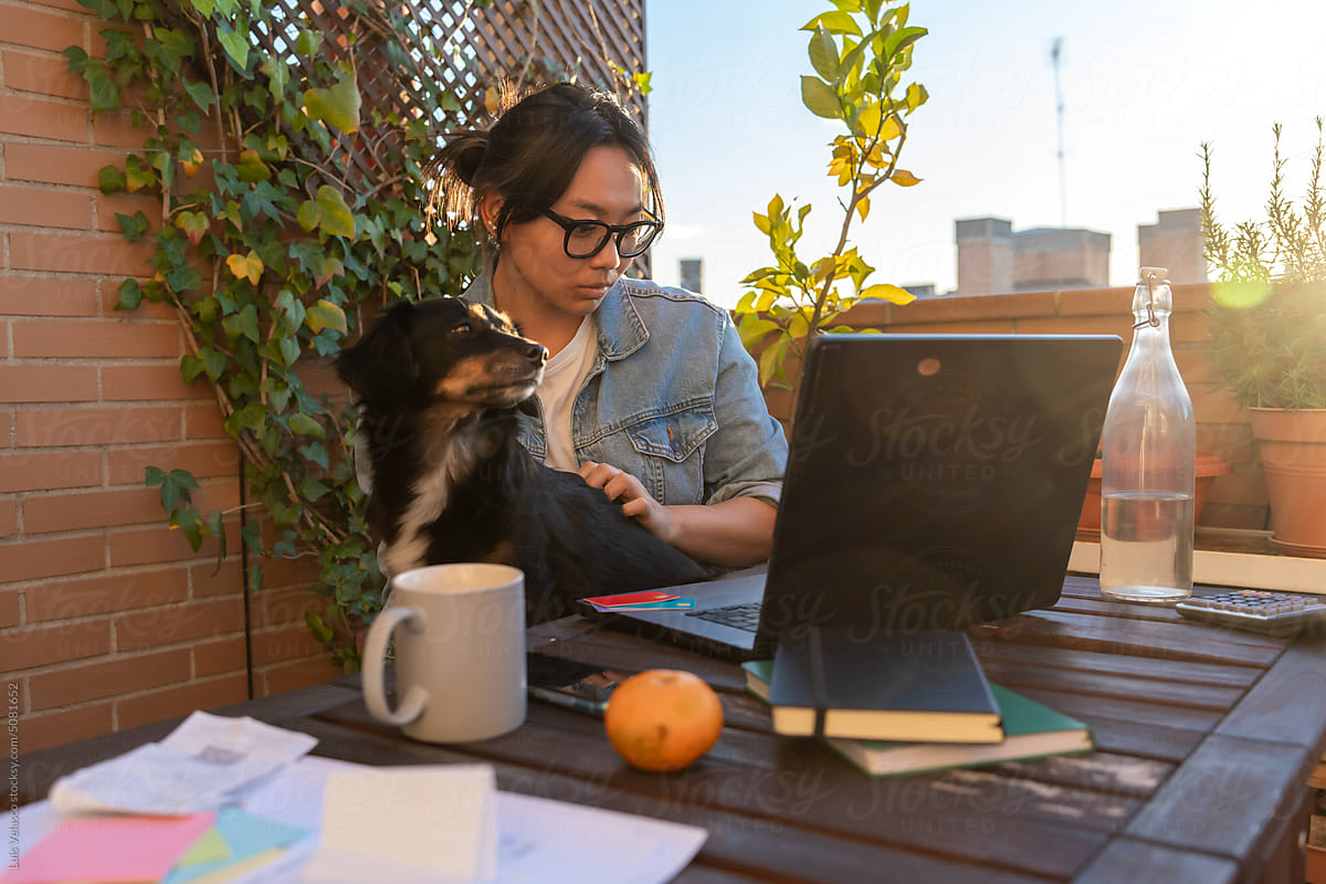 Girl With Dog, Buying Online With Laptop In Her Terrace At Home.