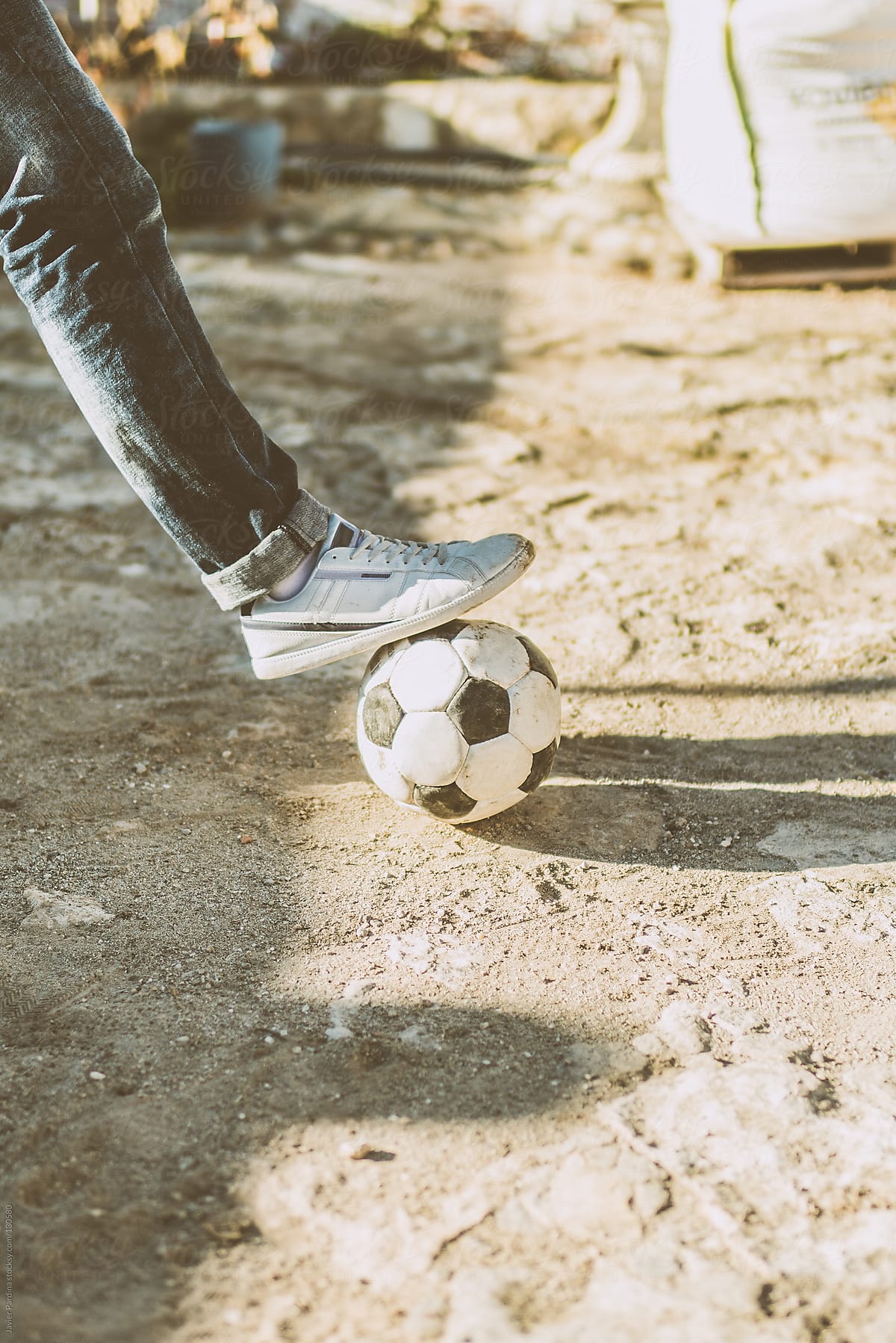 Foot stopping a soccer ball.
