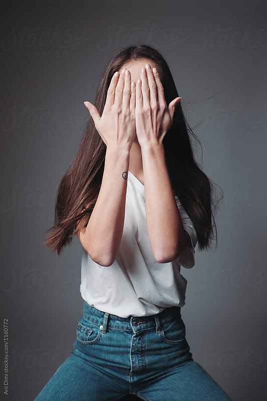Woman covering her face