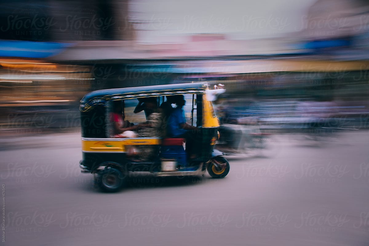 Abstract pan shot of a auto rickshaw in the Indian street.