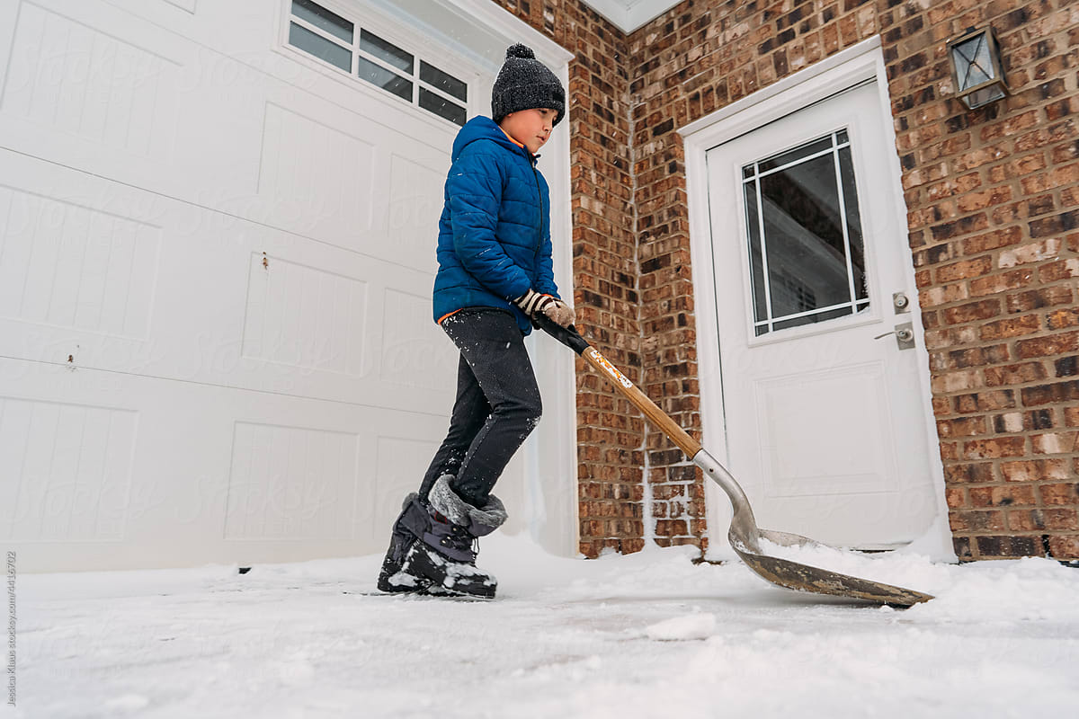Pushing a shovel across fresh snow.