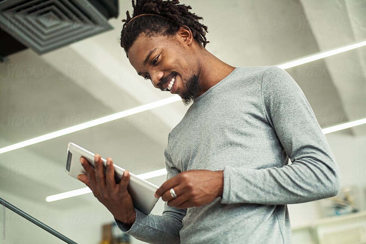 Smiling African Businessman Using a Tablet