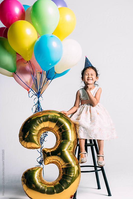 Adorable little girl at her three years birthday party