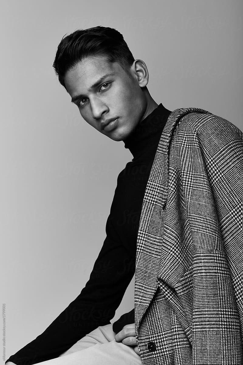 Handsome Indian guy portrait wearing turtle neck and coat on black and white