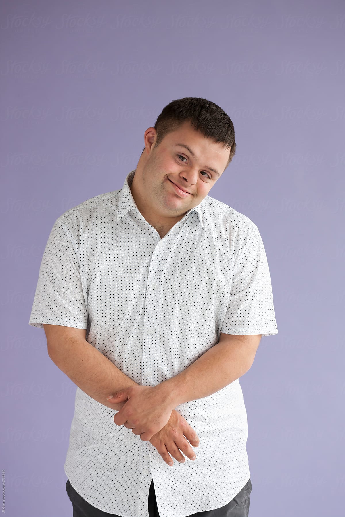 Portrait Of Handsome Young Man With Down Syndrome By Stocksy