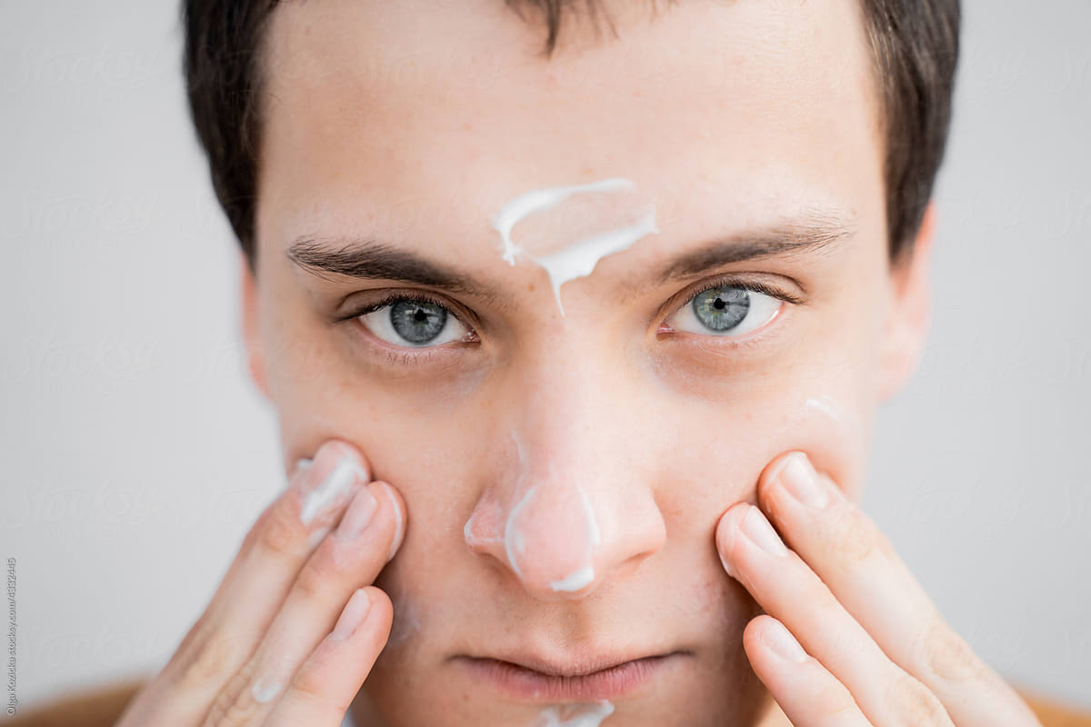 Man Hydrating Face With Cream