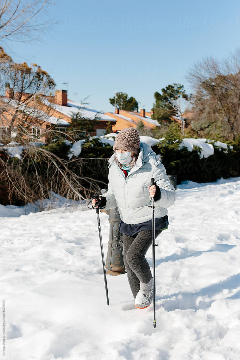 Woman doing Nordic March on the snow