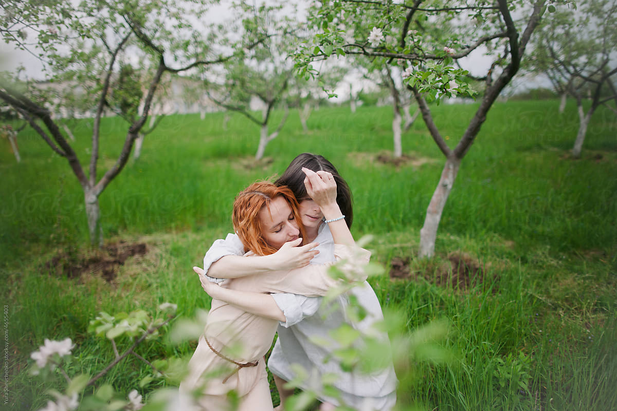 two women contemporary dancers dancing in a blossom garden