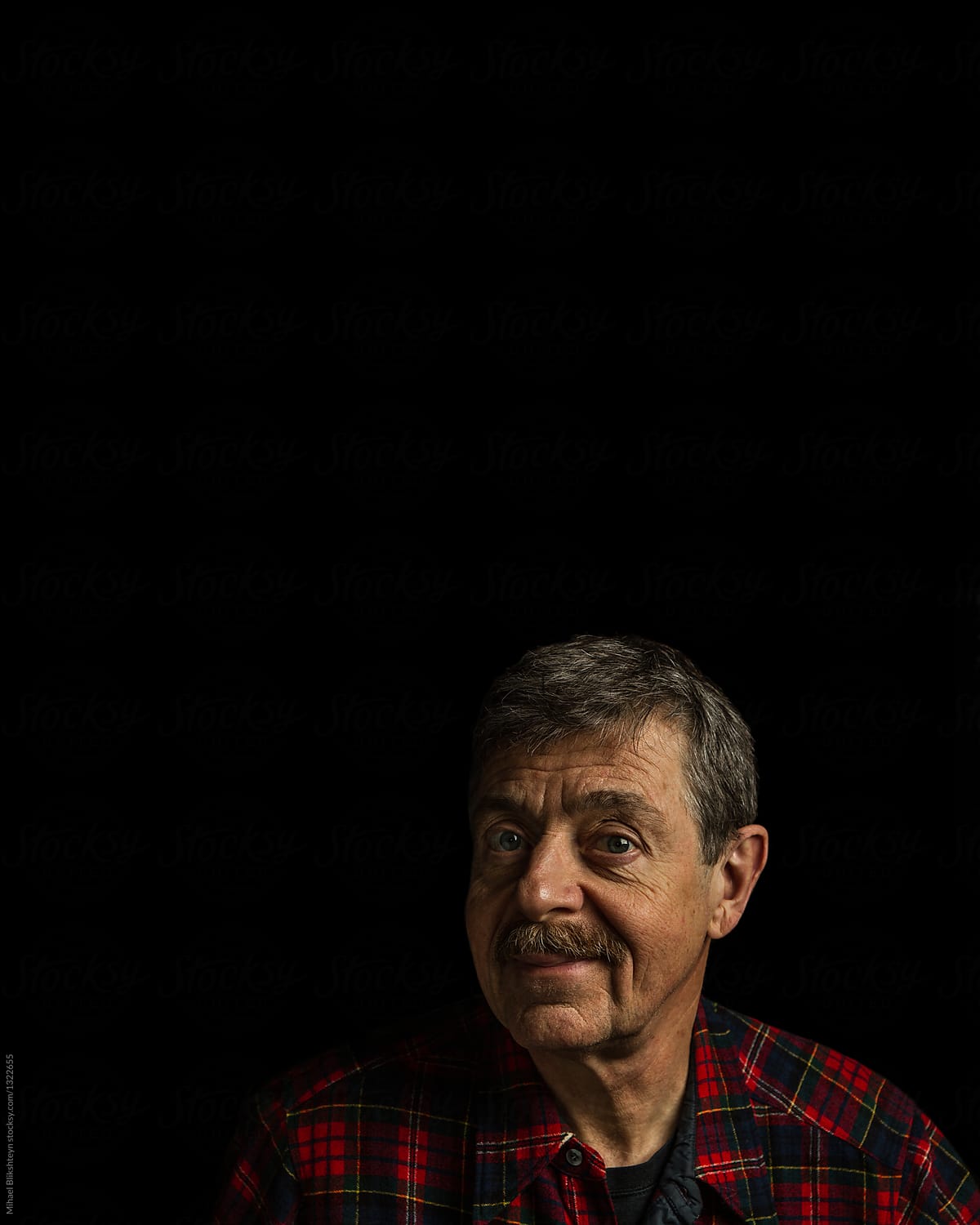 Portrait of a man in plaid button-up shirt isolated on a