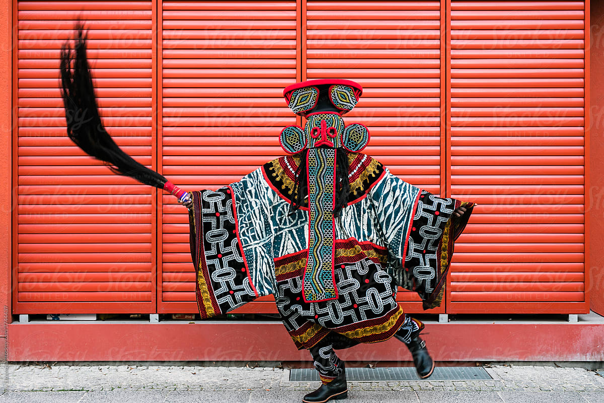 Extravagant African man dancing on the red