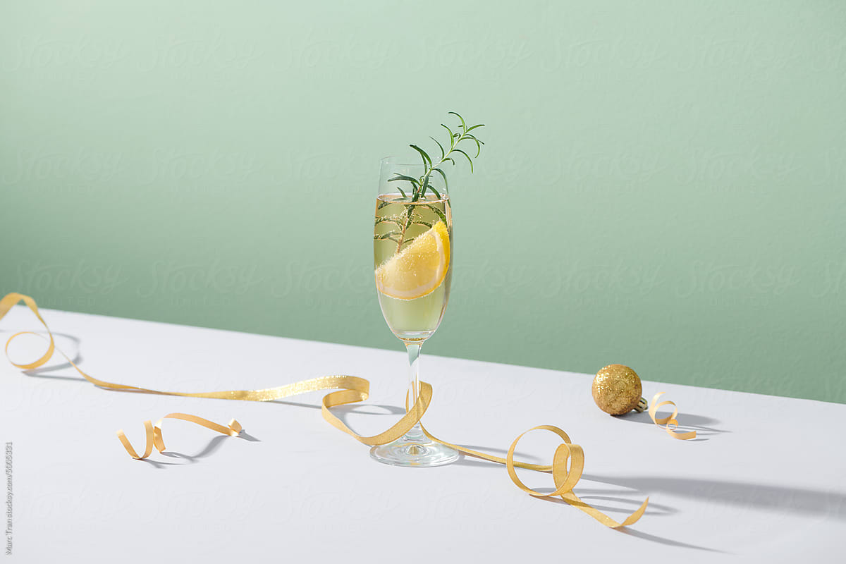 Gin-tonic cocktail with lime, rosemary and ice and christmas ball