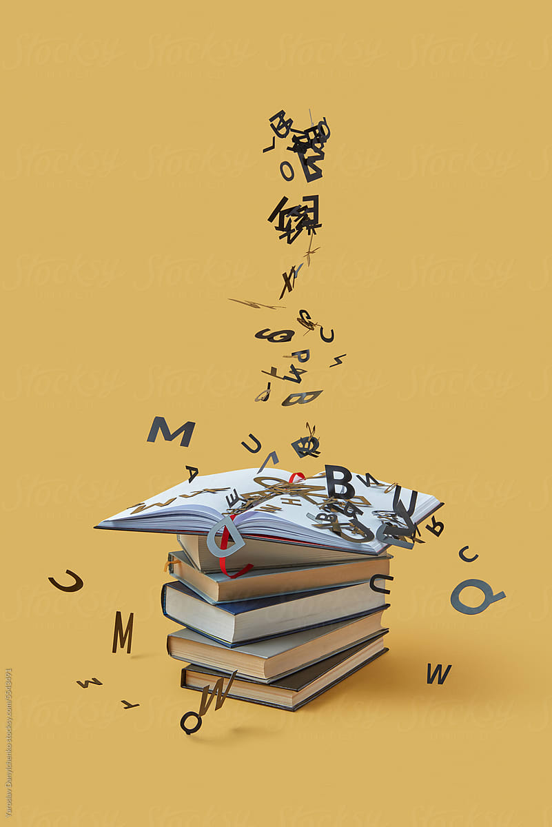 Black letters falling on pile of books.
