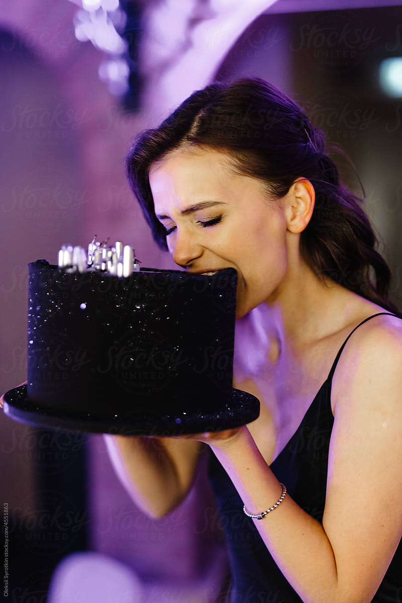 Birthday Girl trying  Bitting Festive Cake during Party