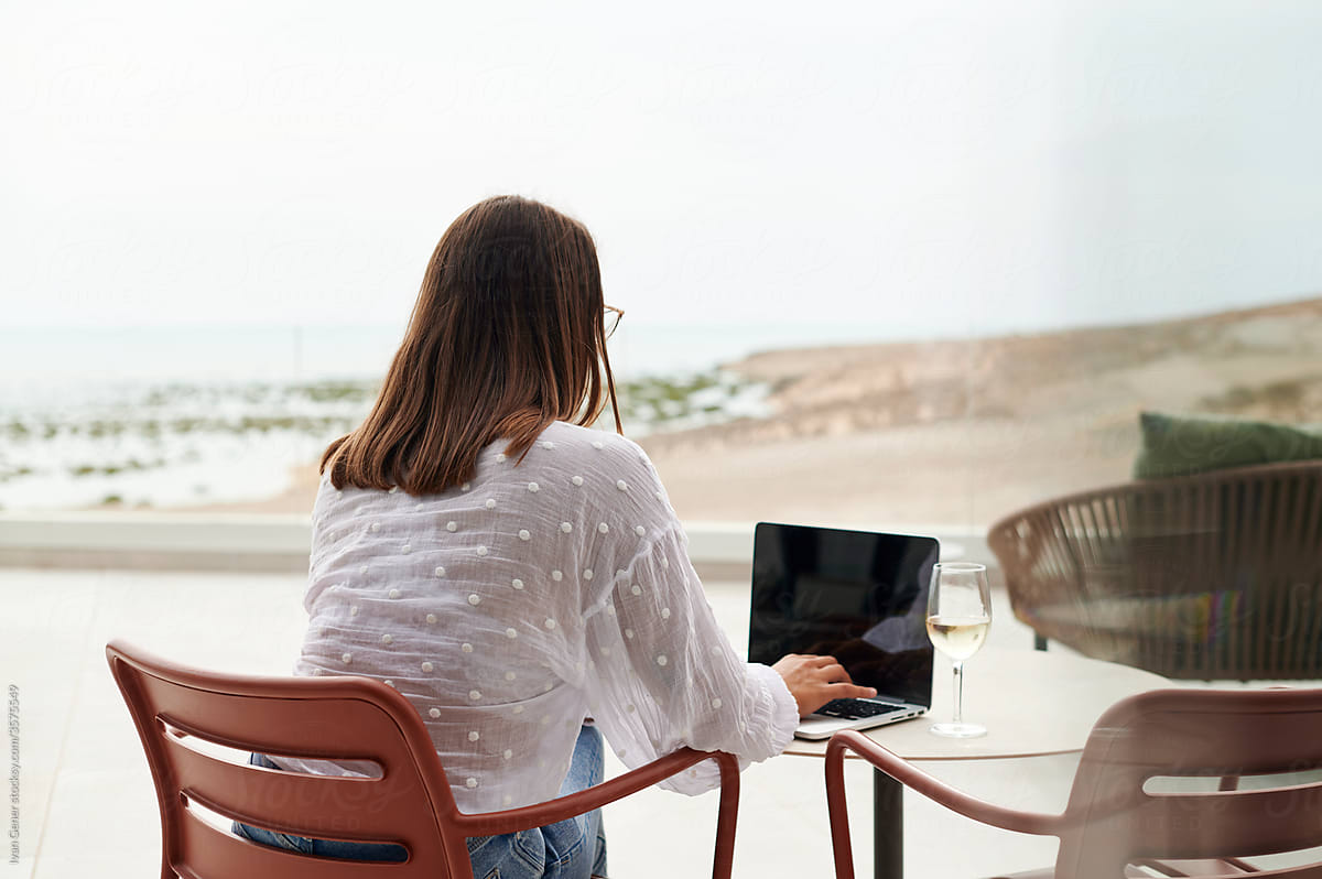 Young woman using a laptop on her patio