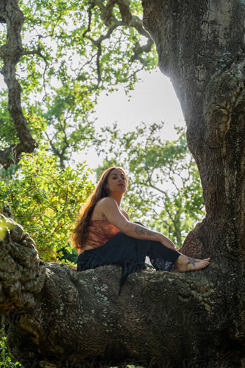 Portrait of Fierce powerful woman on top of tree