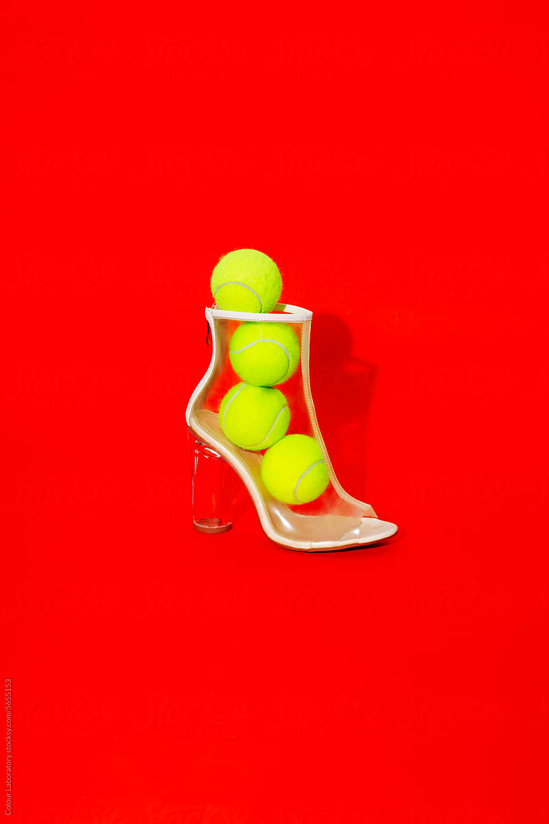 Transparent clear plastic heel and neon yellow tennis balls inside
