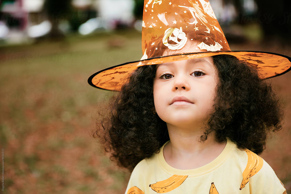 Front view of a little girl wearing halloween hat