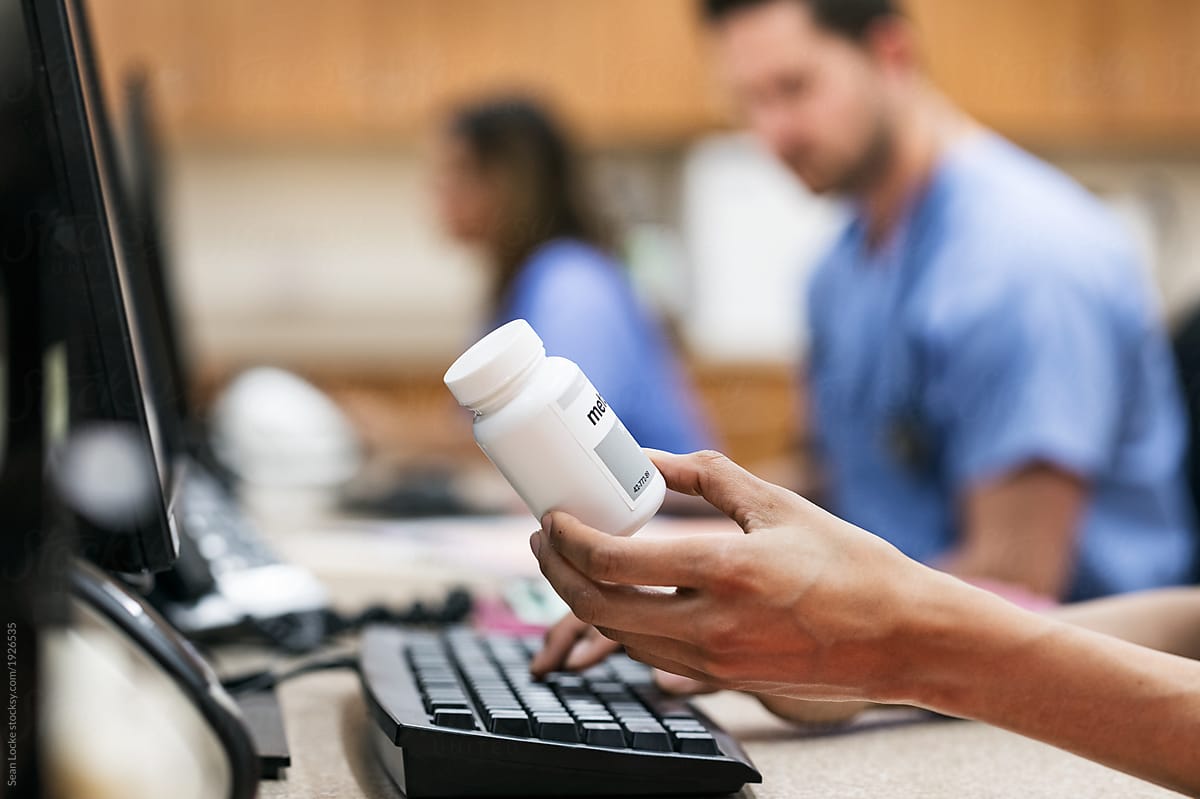 Clinic: Nurse Holding Prescription Medicine Bottle