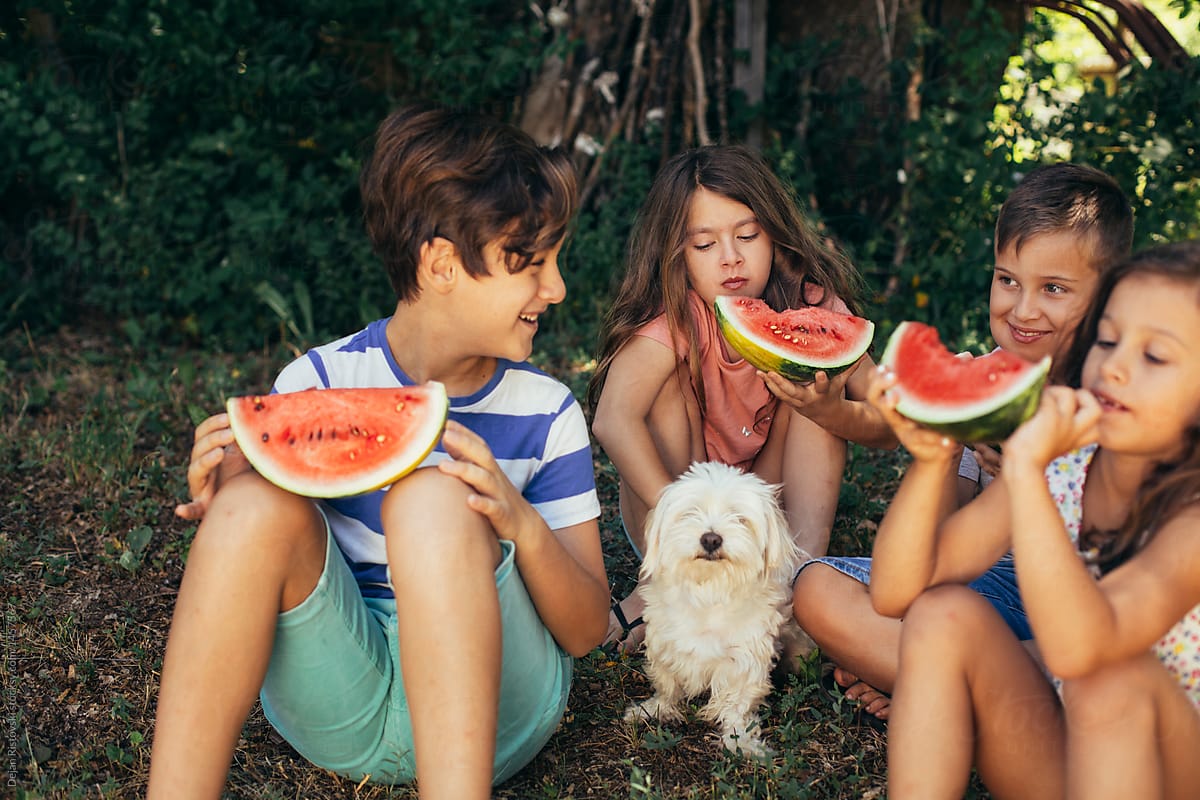 Children eating watermelon.