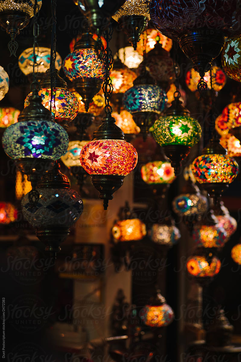 Vintage beautiful illuminated lanterns hanging in small shop