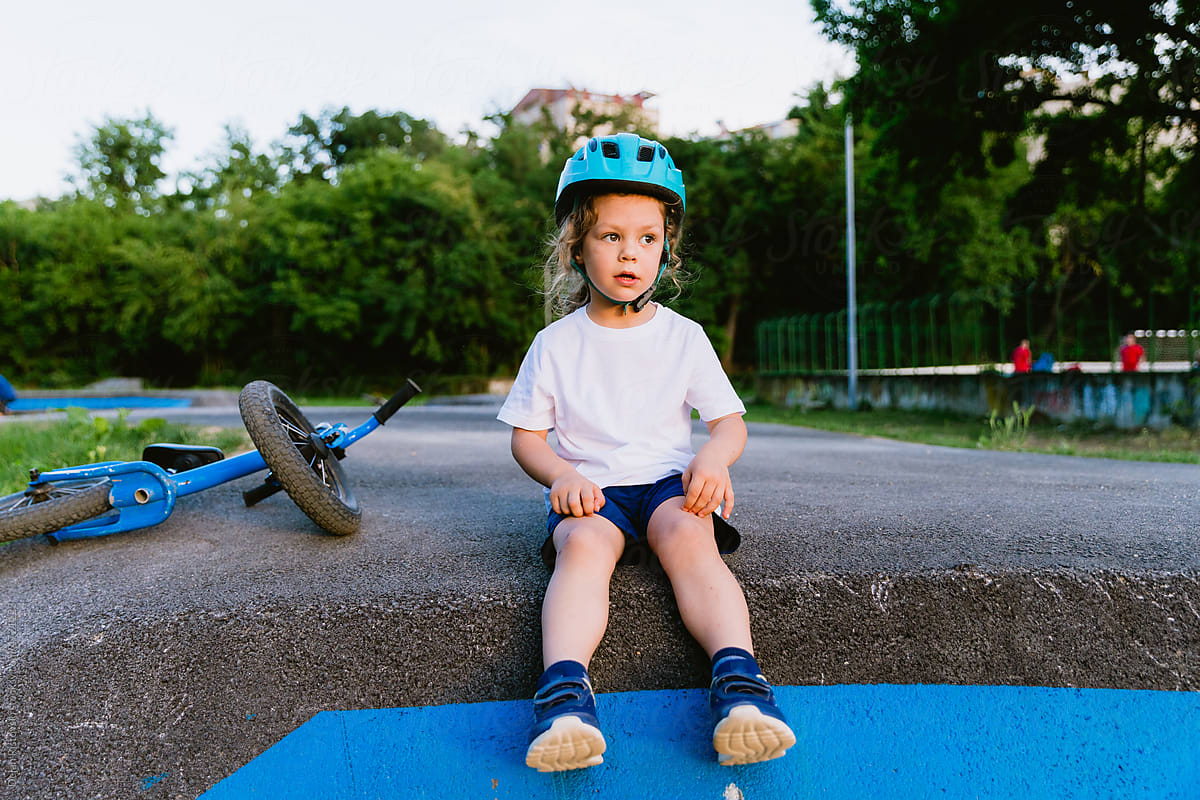 Little boy resting from an active ride at a pump track