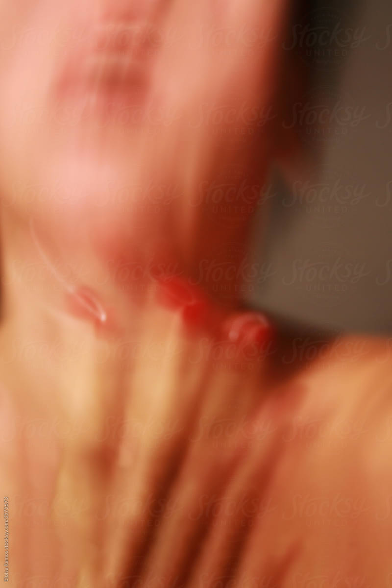 Motion blurred woman portrait with red nails