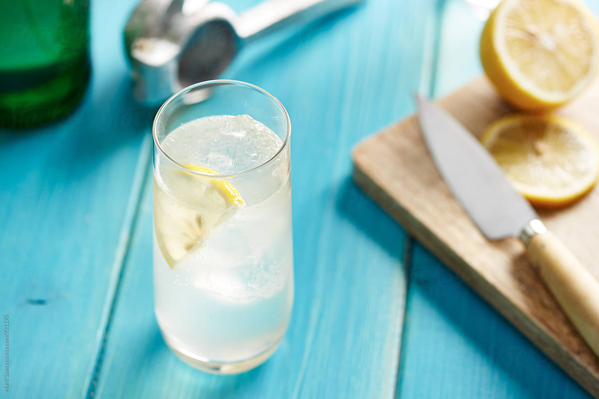 Gin fizz cocktail, knife and lemon