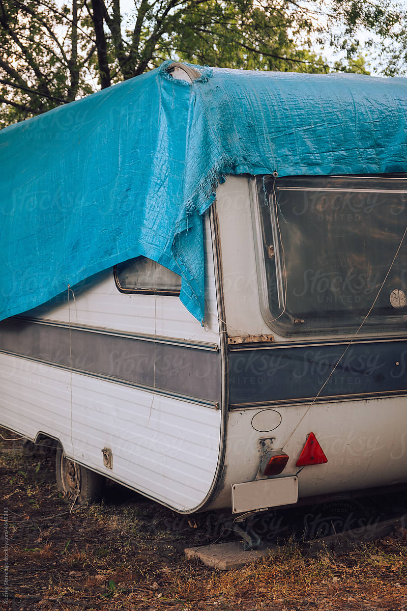 Camping trailer covered in blue awning