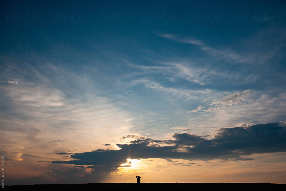 Silhouette of woman watching the sunset