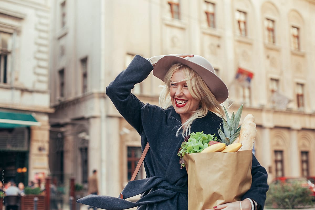 Beautiful Happy Woman With a Bag of Groceries