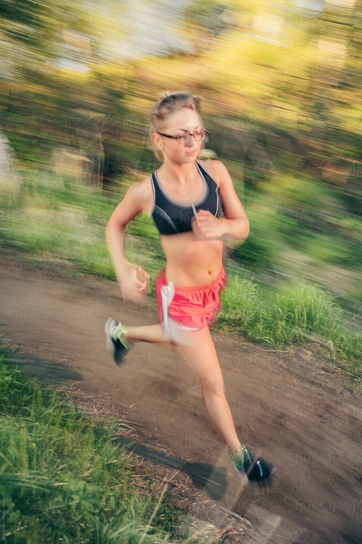 Panning With a Woman Running on a Dirt Trail