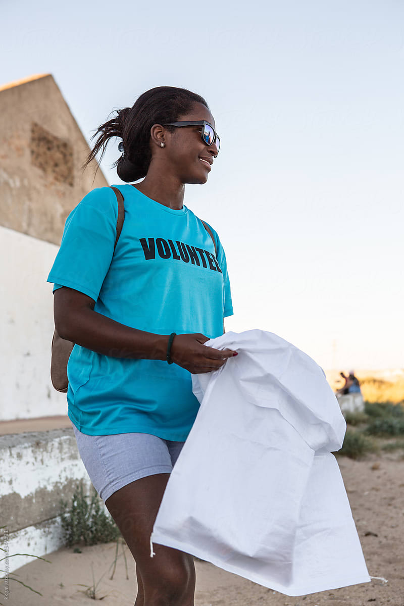 Female volunteer at the beginning of a beach clean up