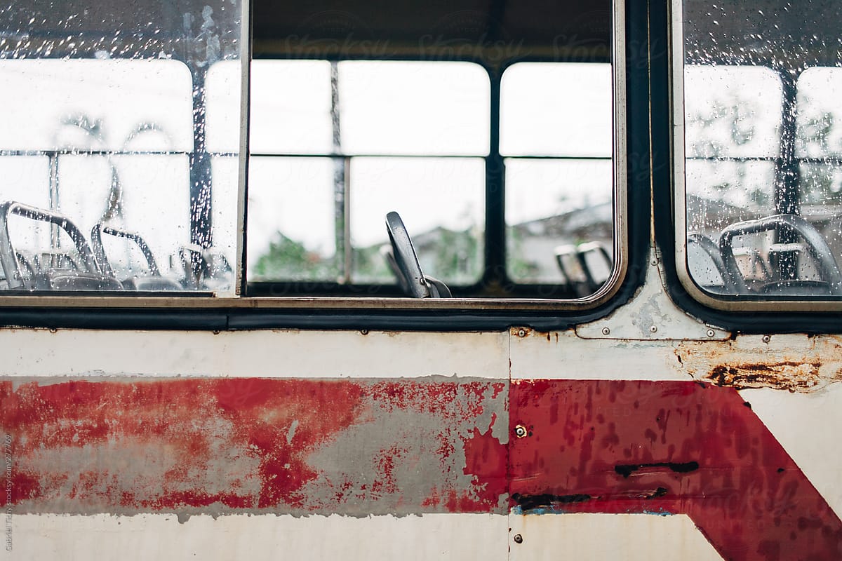 Side of an old bus with empty seats