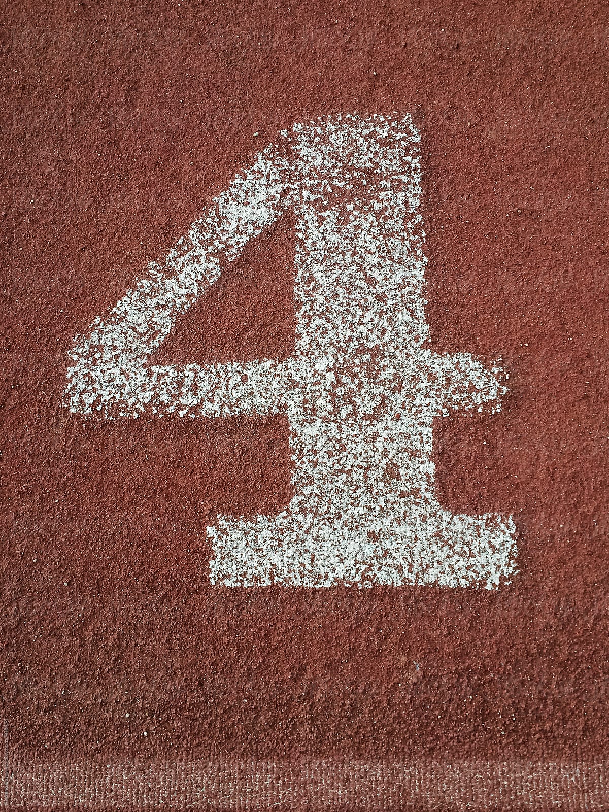 white number four painted on an running track