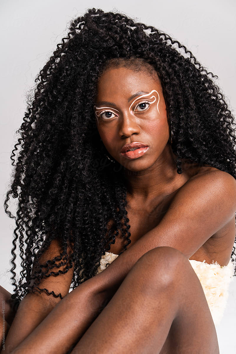 Portrait Of A Black Woman With White Creative Makeup.