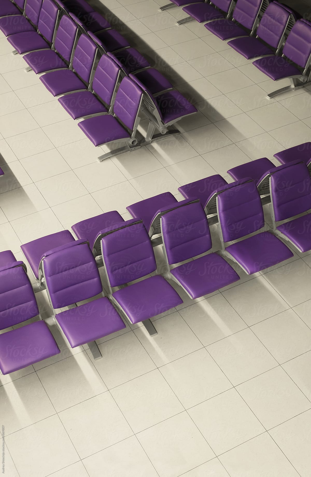 Purple chairs in airport waiting space