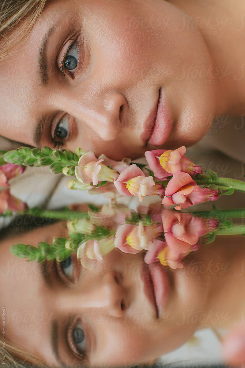Beautiful young natural looking woman with flowers