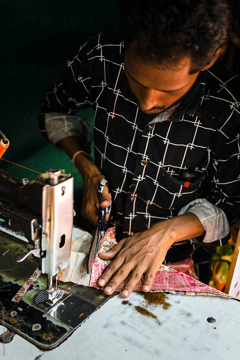 Ethnic craftsman sewing bag in workshop