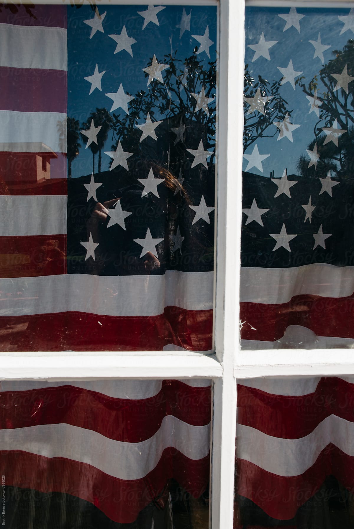 United States flag behind a closed window