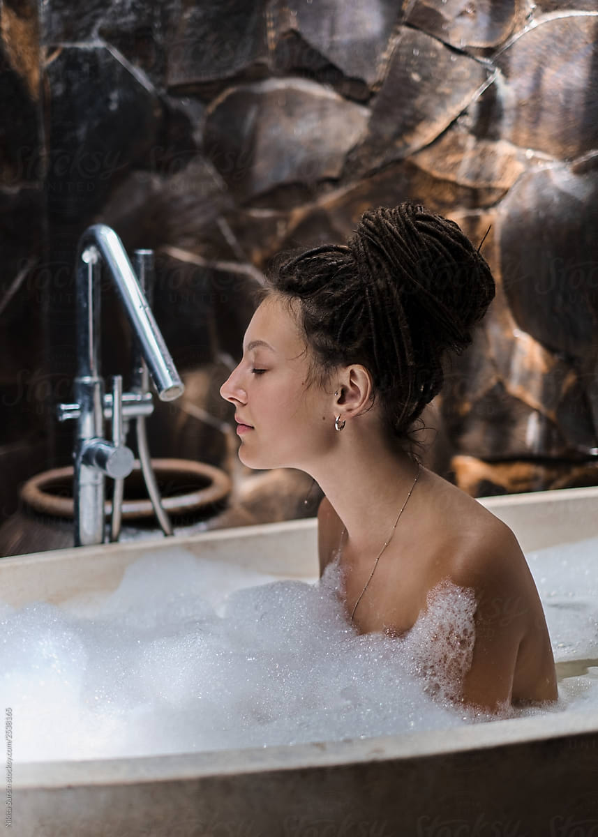 Attractive unusual girl takes a hot bath