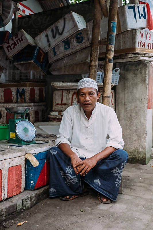 Indonesian Middleaged man runs a fish business on local market