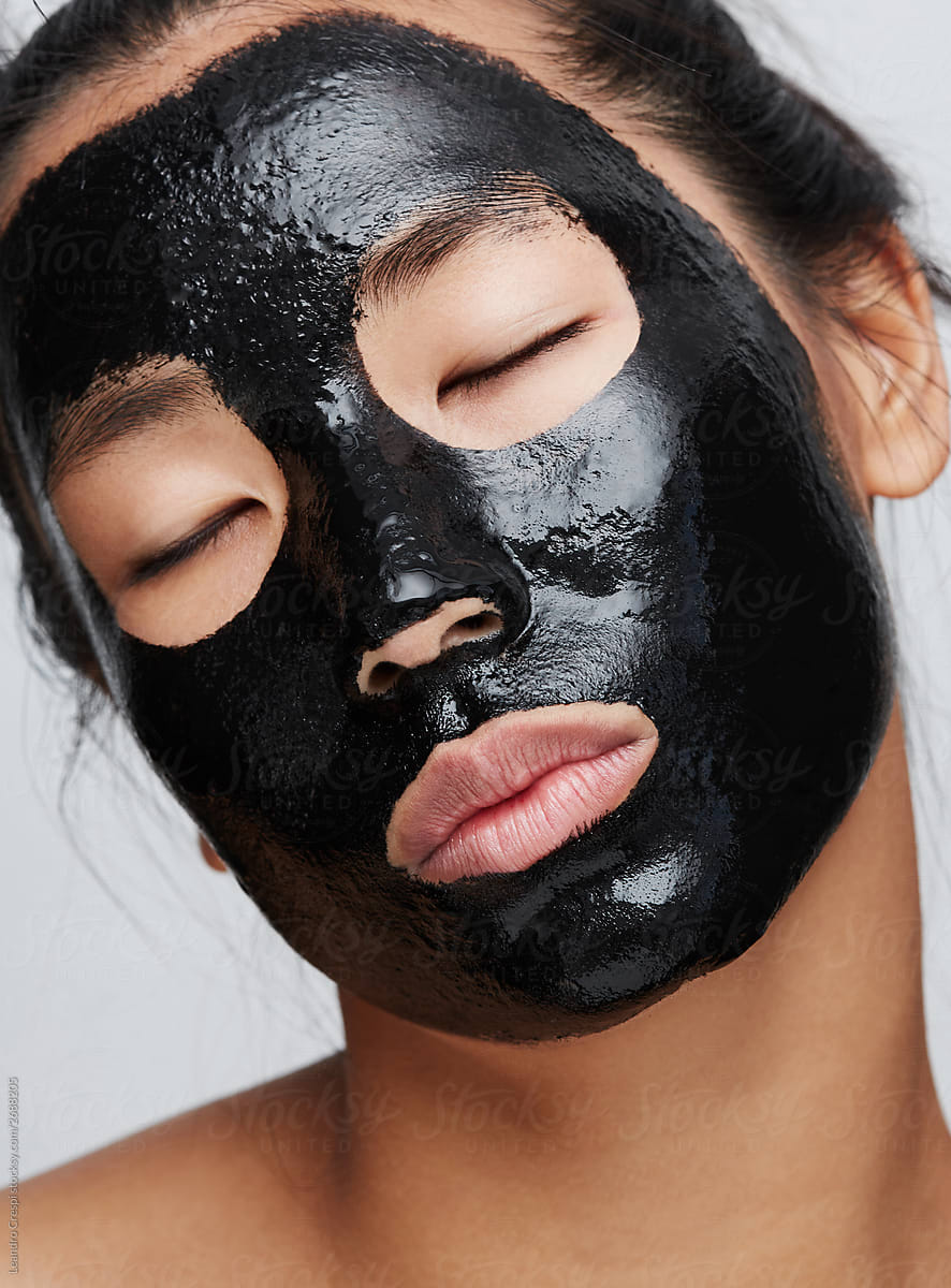 Woman using charcoal mask